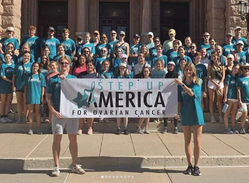 Large group of people posing with a step up america banner and wearing STAAR's Step Up America for ovarian cancer tshirts and enjoying a fun fundraising event to benefit low grade serous ovarian cancer lgsoc research